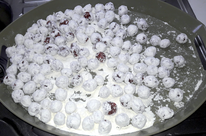 cover themeatballs with wheat flour on tray