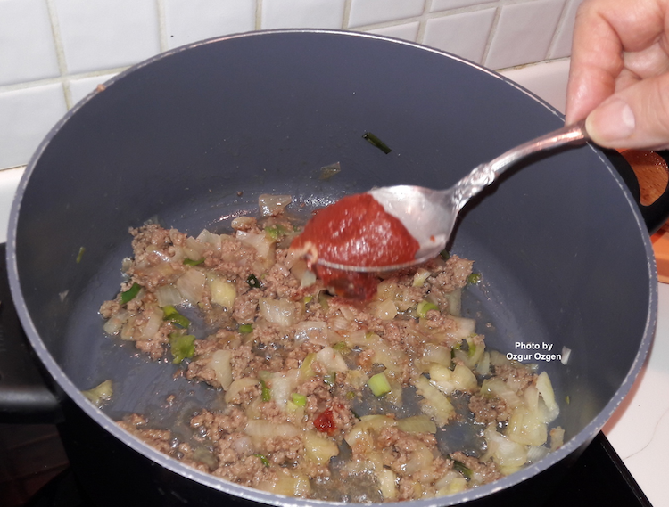 add tomato paste into saucepan